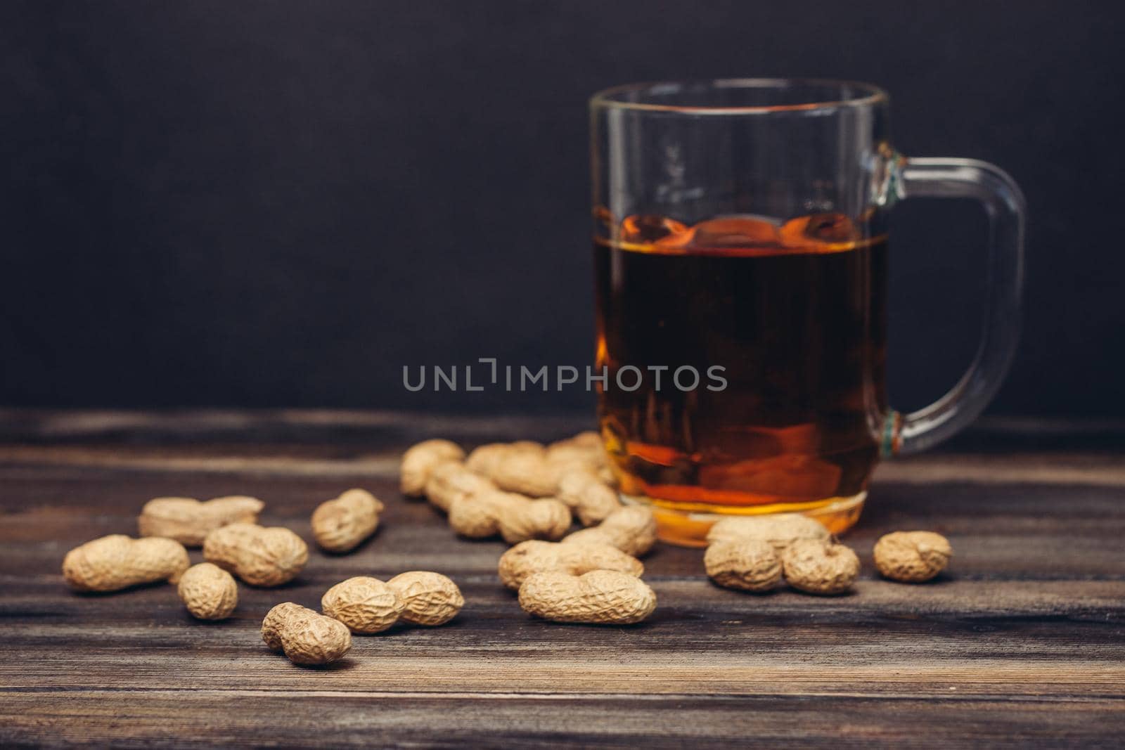 bar wood counter beer mug peanuts snack alcohol. High quality photo