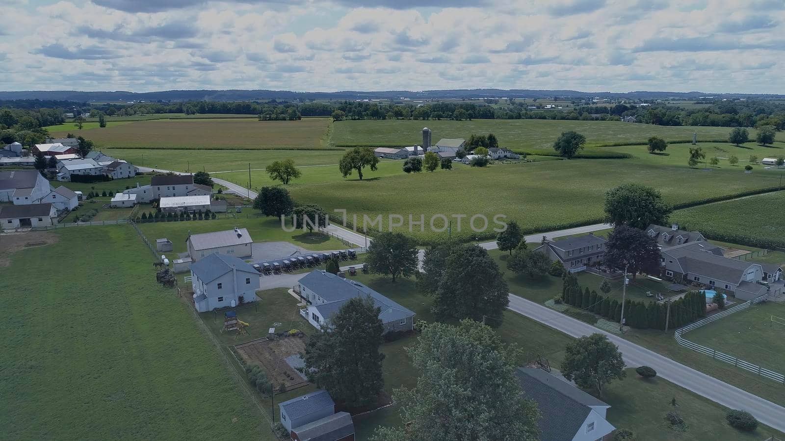Aerial View of Green Farmlands With Different Crops Growing in the Fields on a Sunny Day