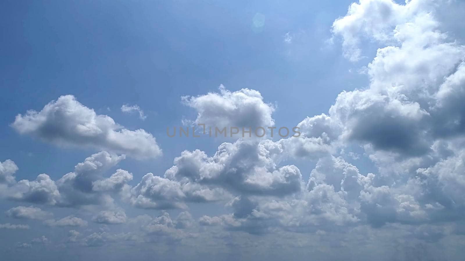 Blue Sky with White Fluffy Clouds as a Back Ground