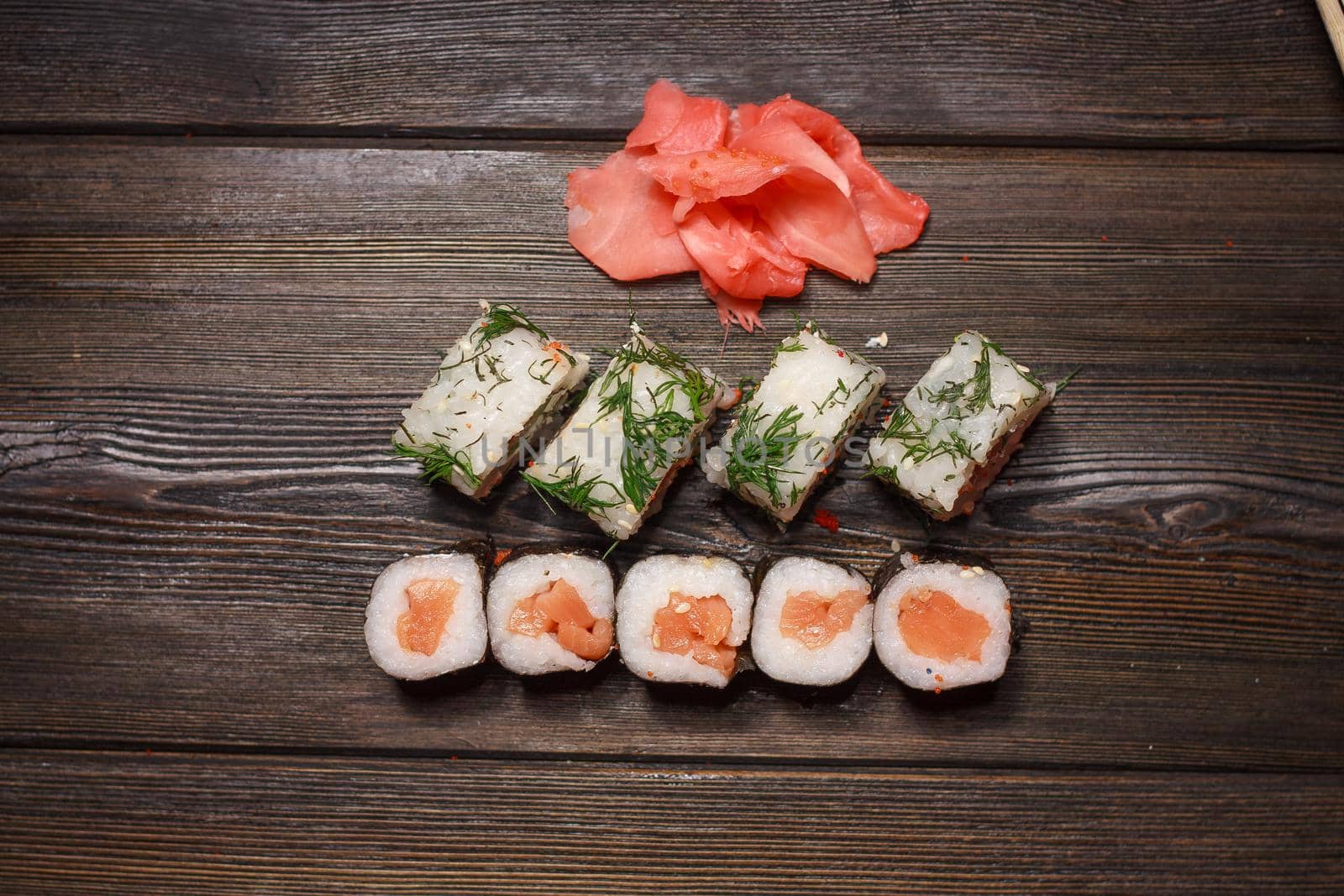 set of sushi and rolls on a wooden table asian food ginger wasabi japanese cuisine. High quality photo