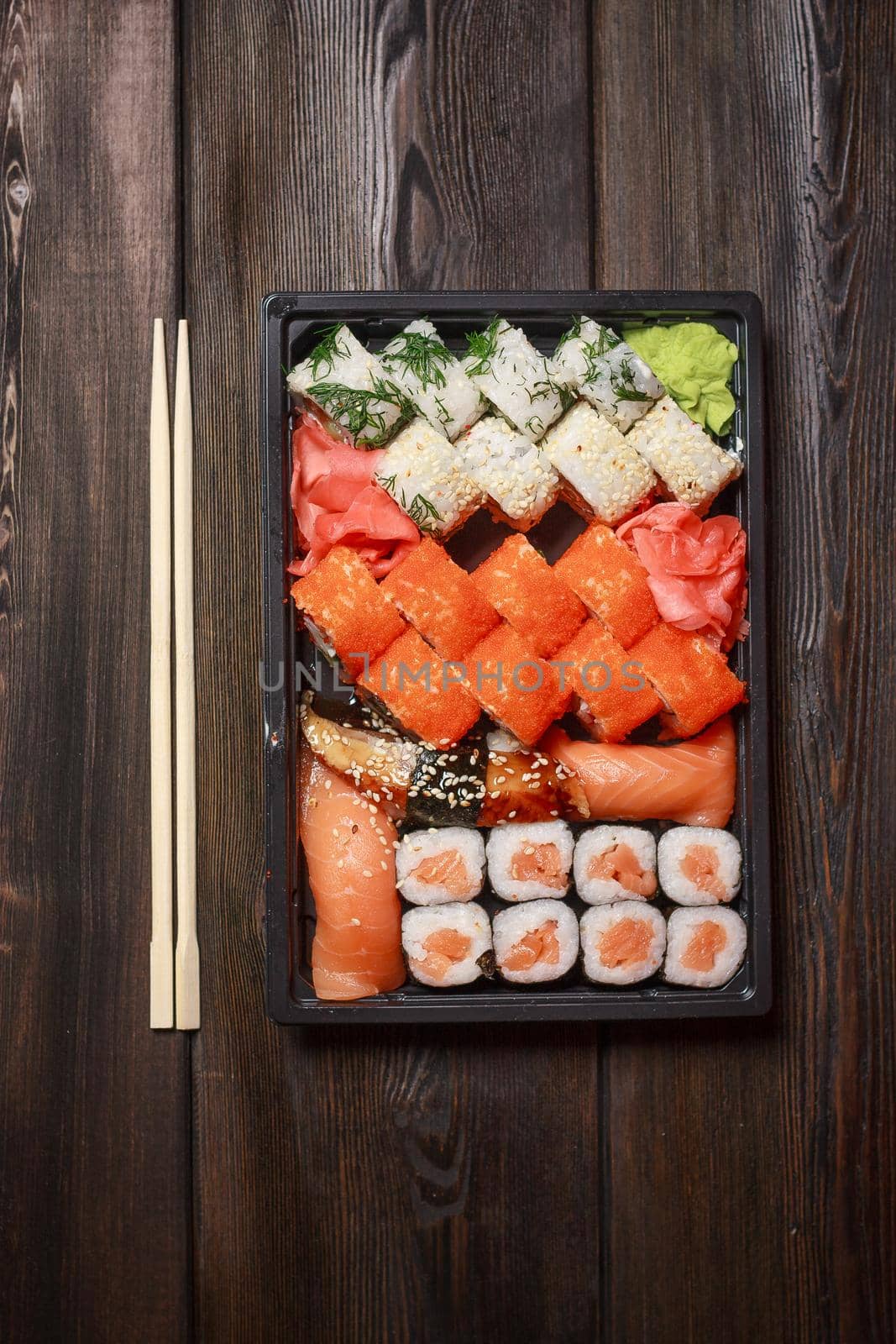 set of sushi and rolls seafood wooden table chopsticks wasabi. High quality photo