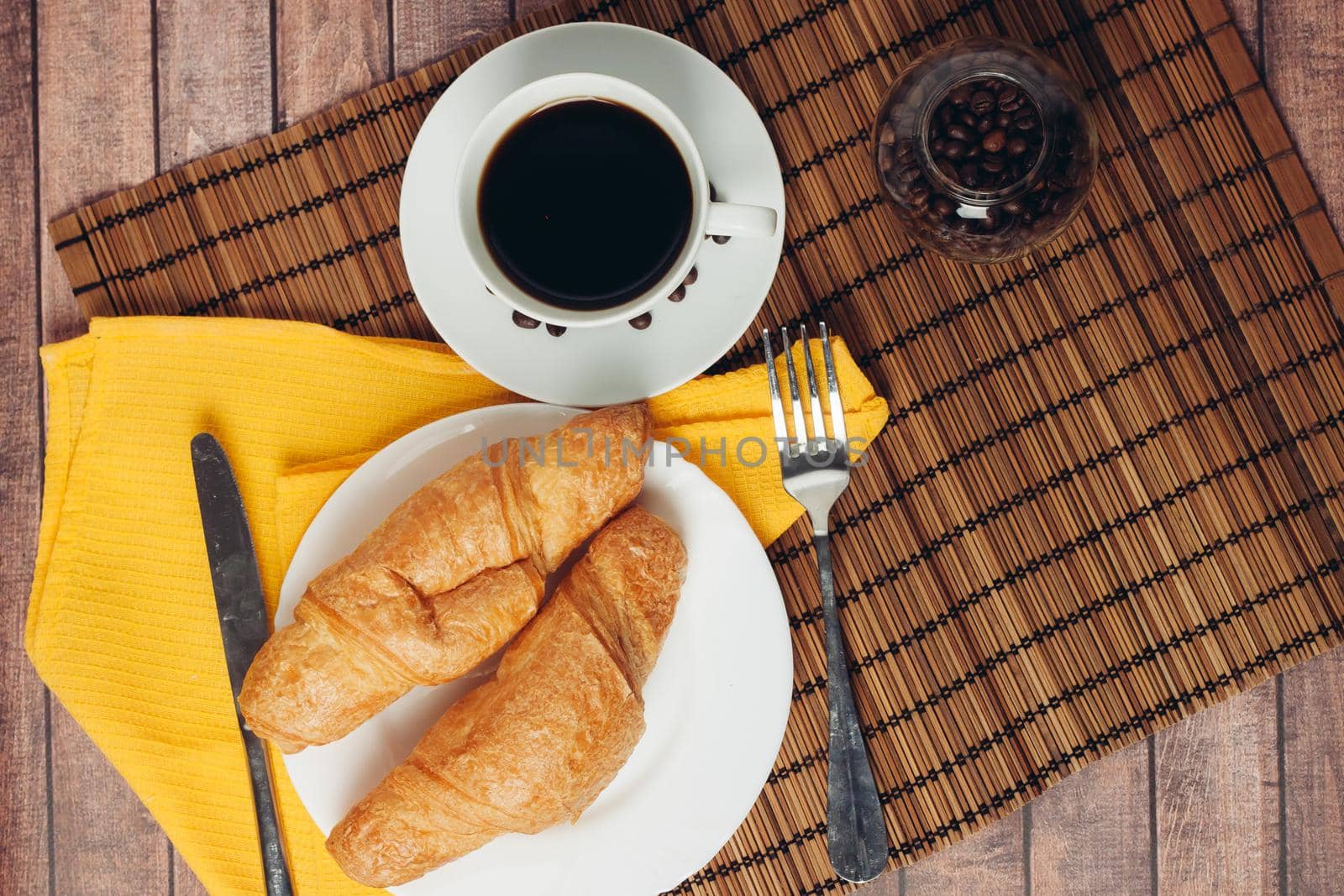 fresh croissants on a plate on the table breakfast dessert. High quality photo