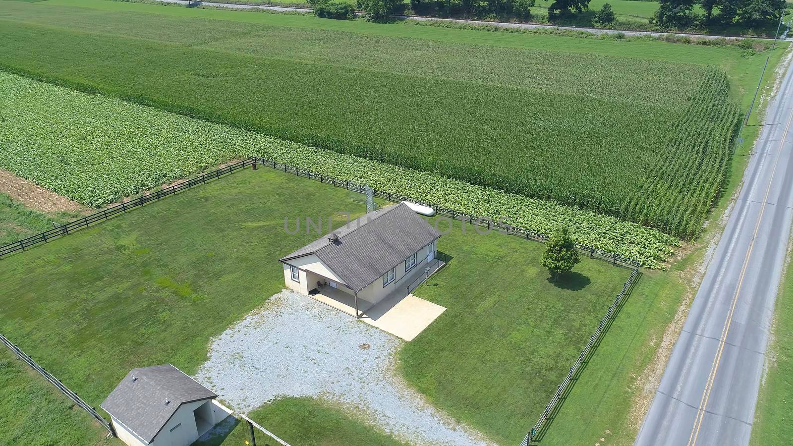 Aerial View of an Amish One Room School House in the Middle Of Amish Farmlands on a Sunny Day
