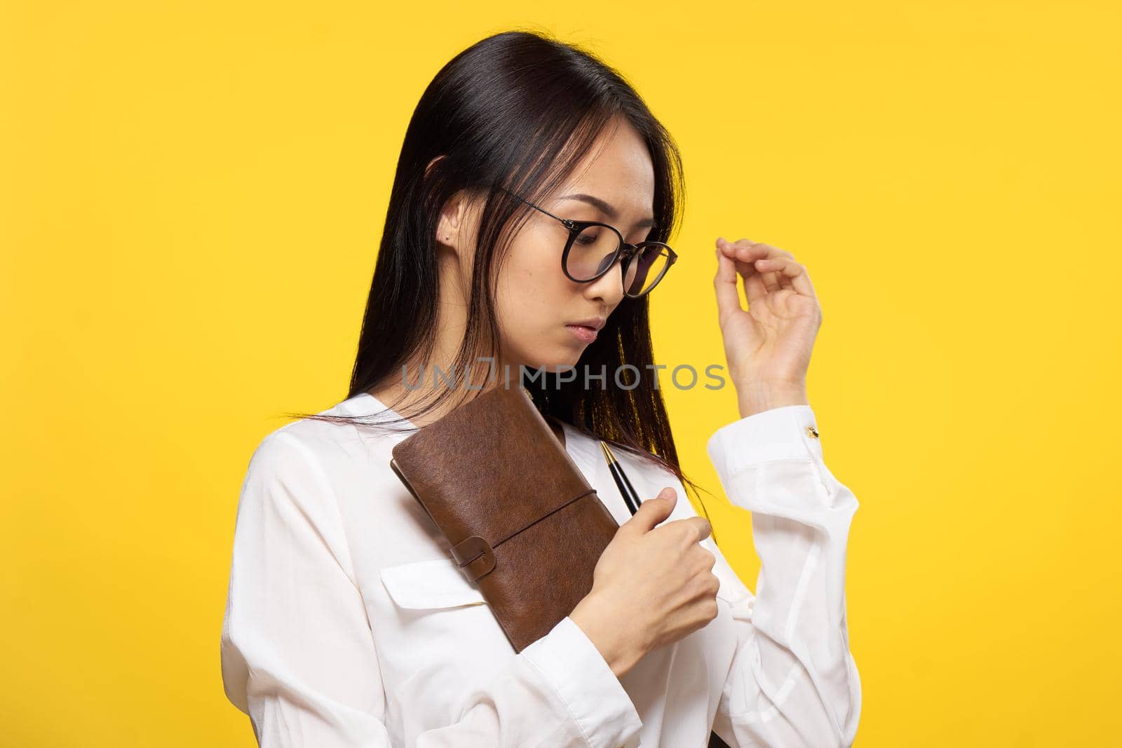woman asian appearance executive notepad manager hand yellow background by SHOTPRIME