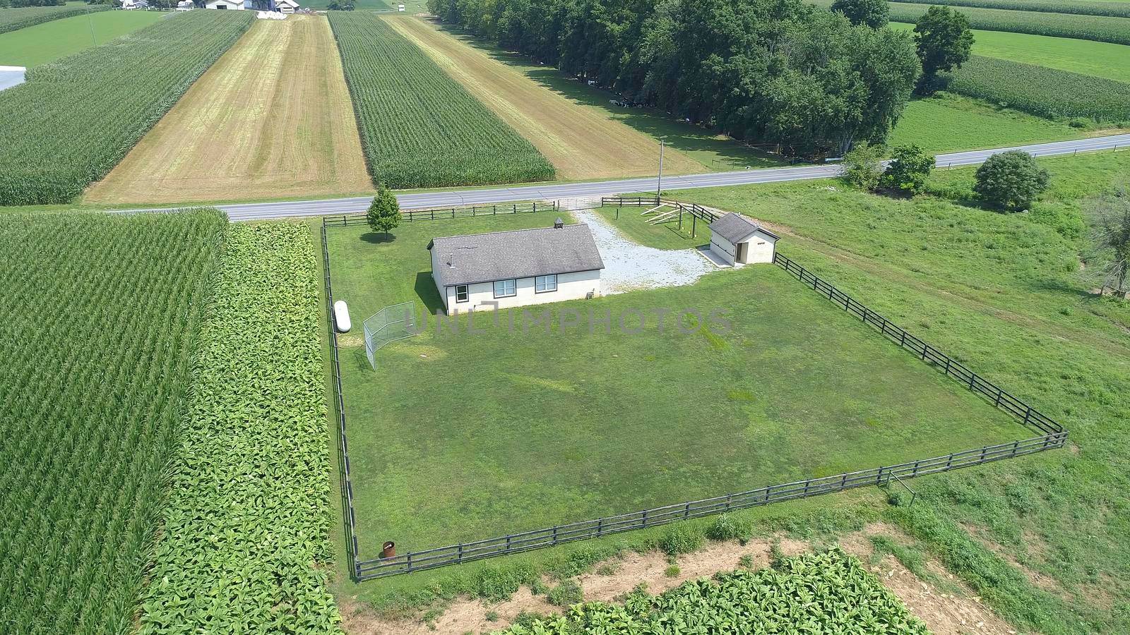 Aerial View of an Amish One Room School House in the Middle Of Amish Farmlands on a Sunny Day