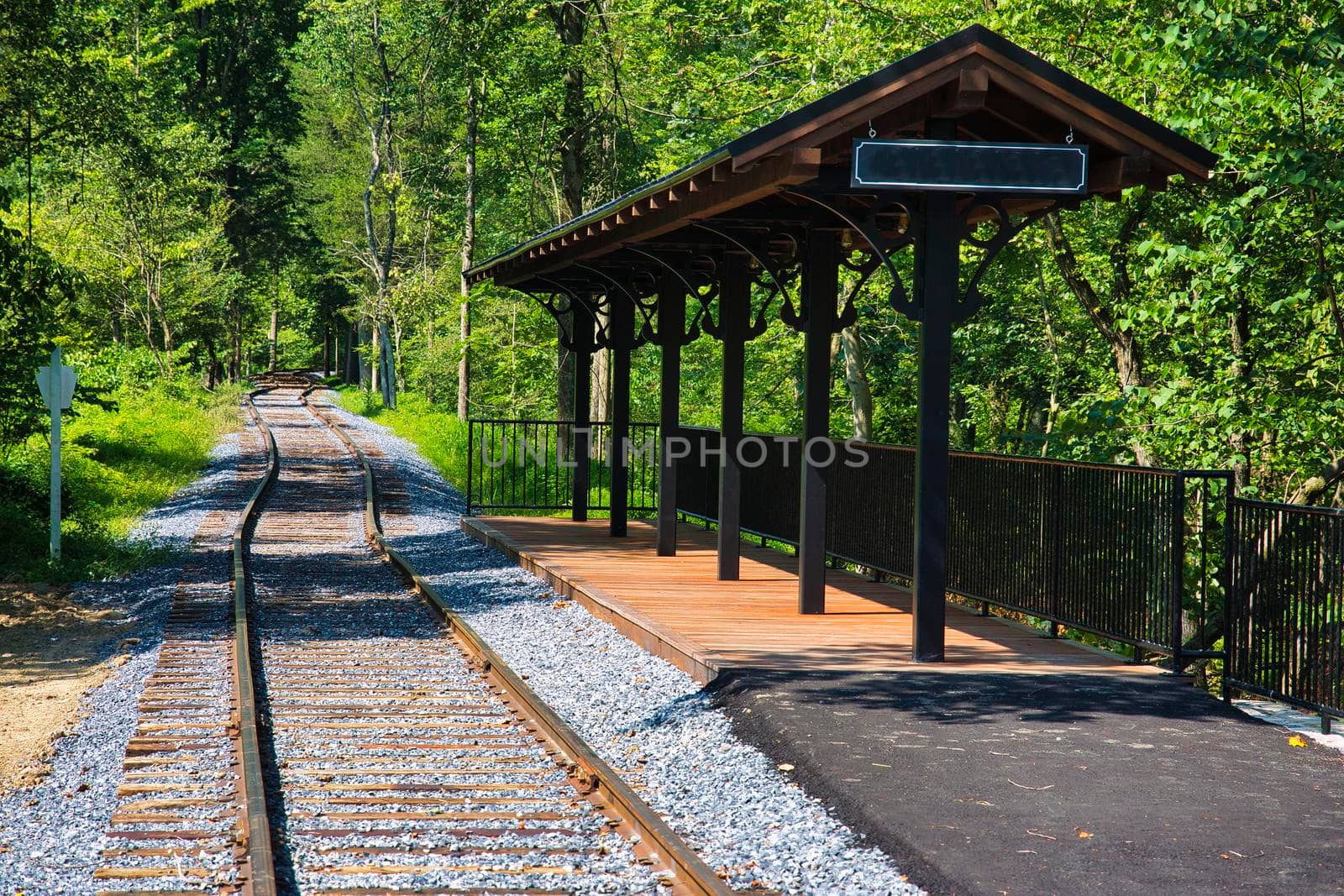 A Small Train Station Waiting for Passengers and a Train