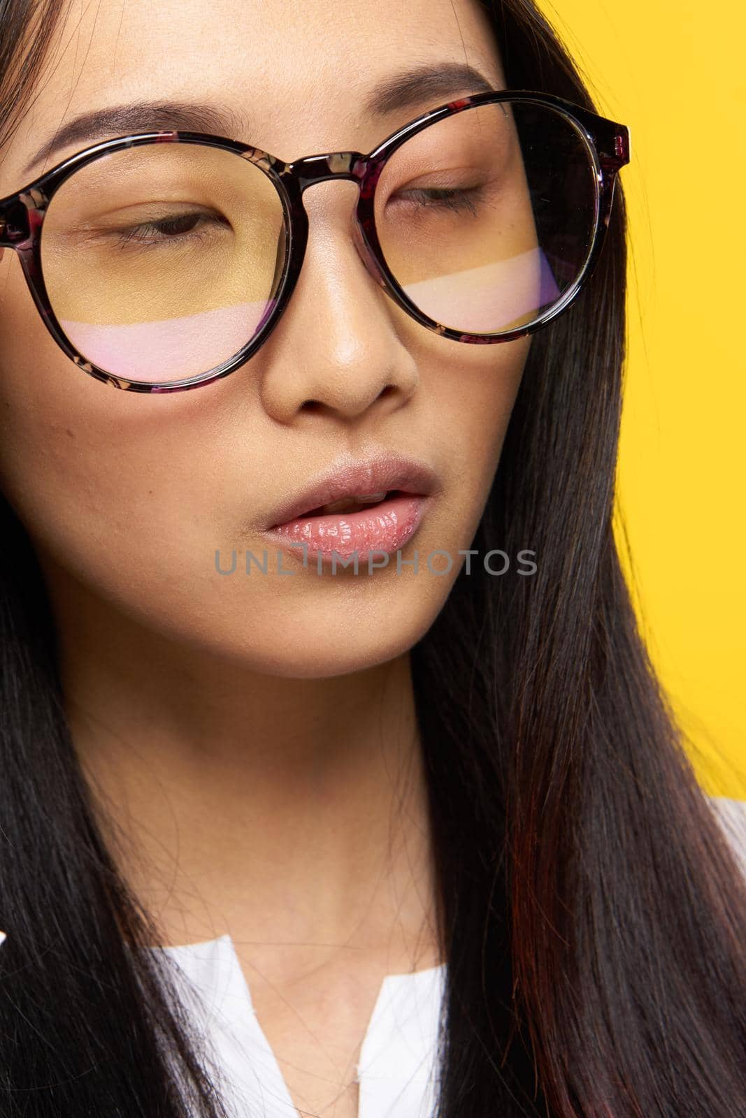 elegant woman of asian appearance with glasses close-up attractive look. High quality photo