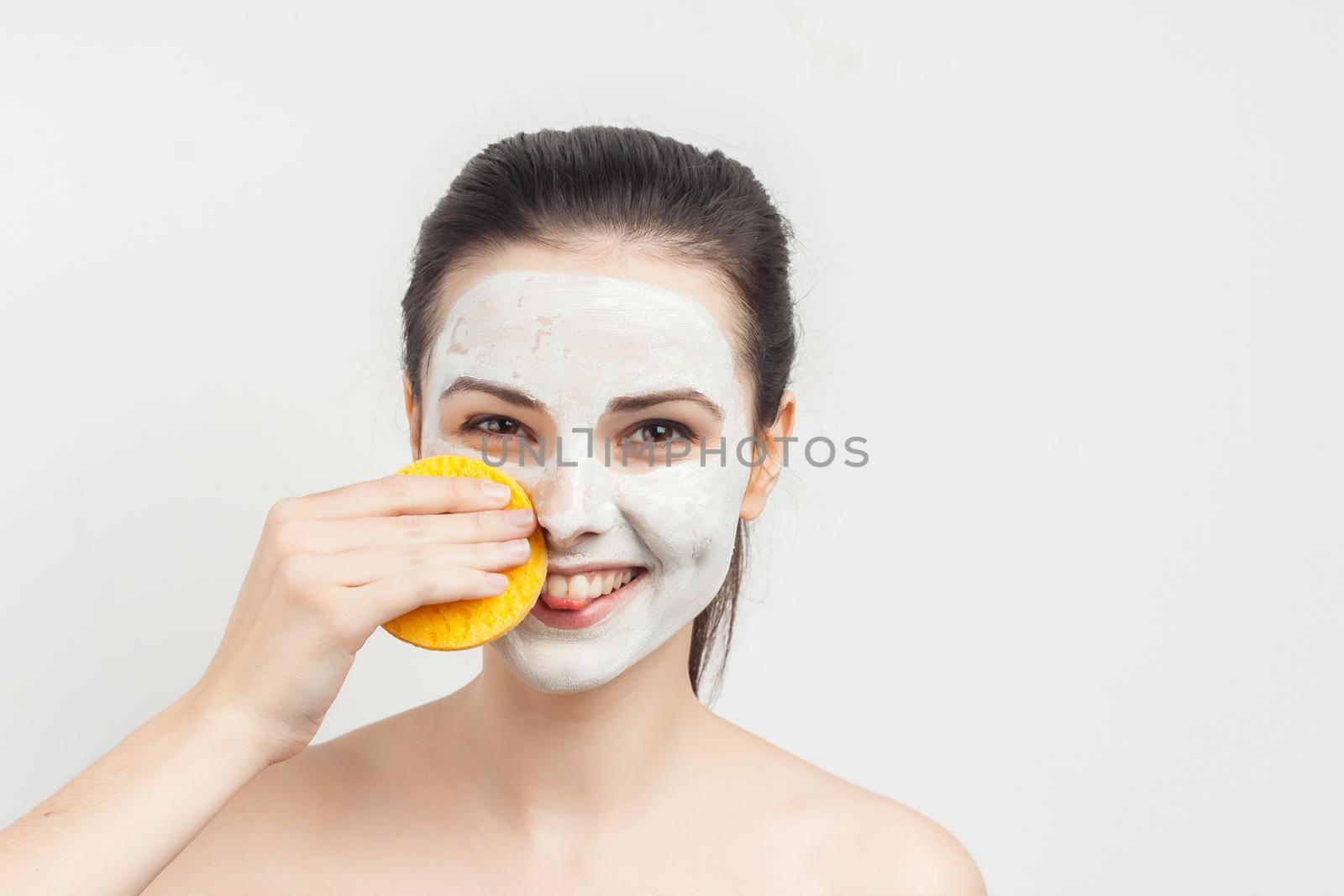 perky brunette with facial mask rejuvenation spa treatments. High quality photo