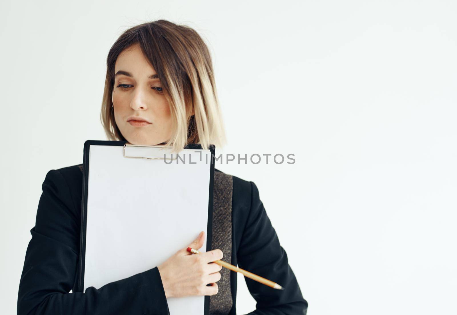 Beautiful woman in jacket with dad documents white sheet of paper mockup. High quality photo