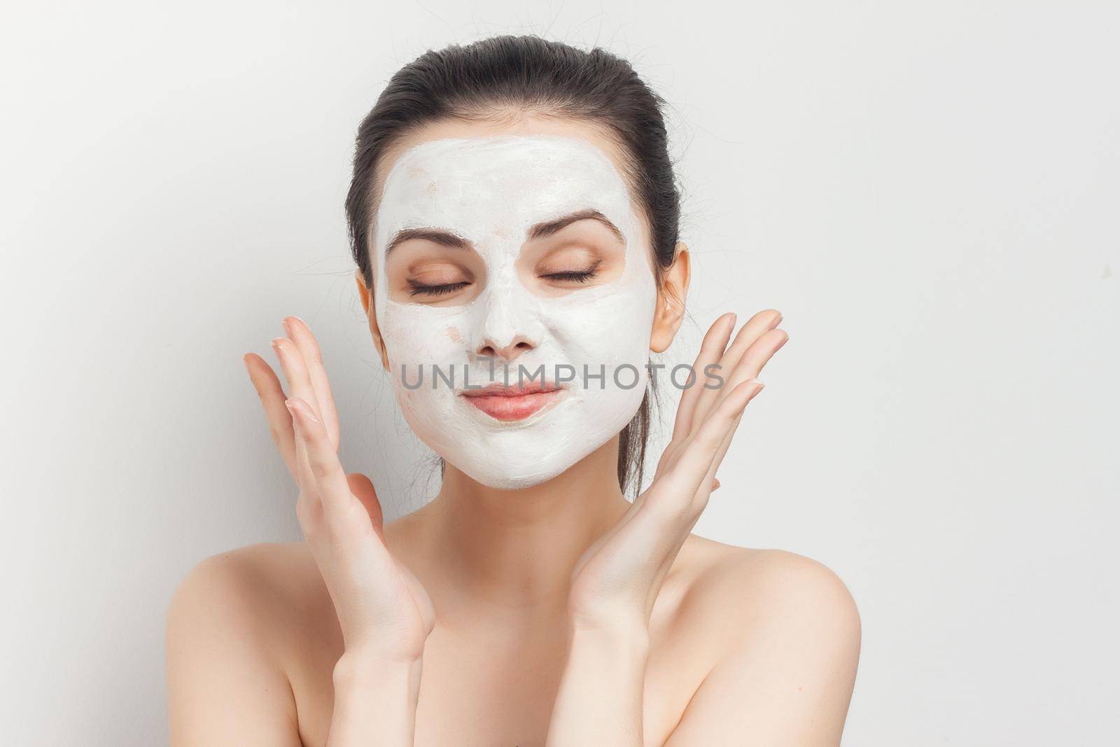 woman with face cream mask skin care naked shoulders spa treatments. High quality photo