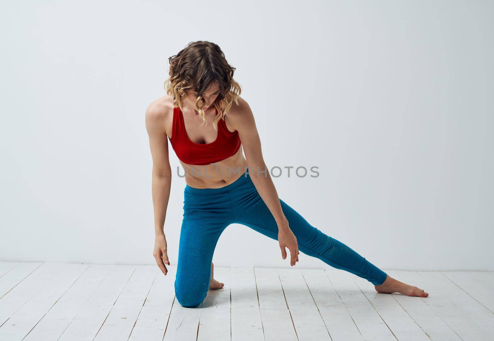 Woman in sportswear doing yoga asana exercises model light room. High quality photo