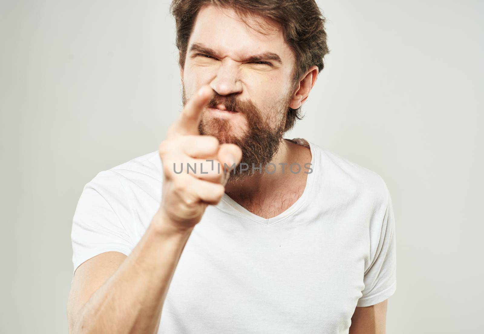 emotional man gesturing with his hands on a light background aggression scream by SHOTPRIME