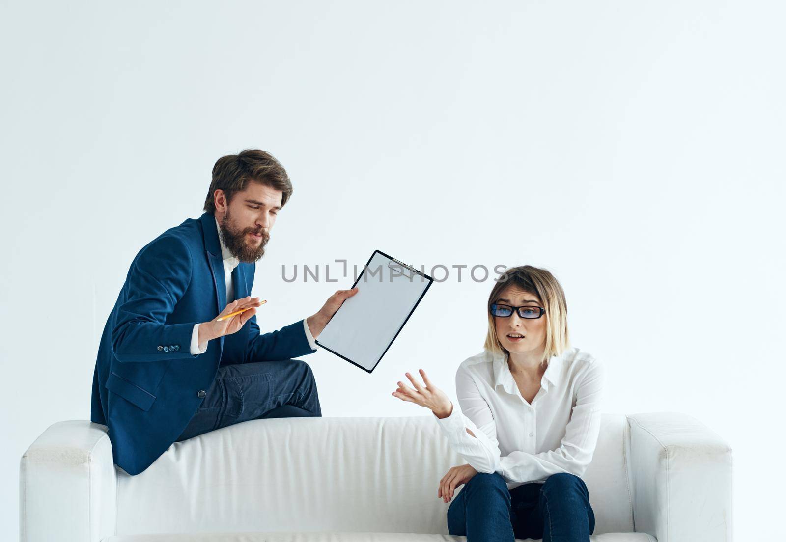 business man and woman team of professionals white sofa communication. High quality photo