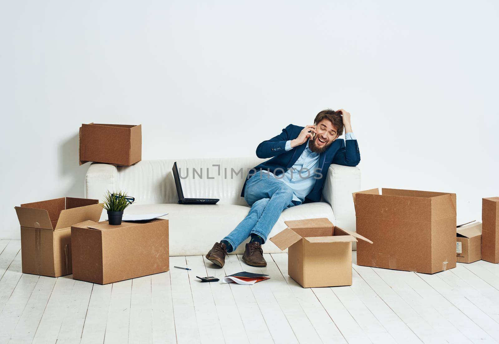 a man sitting on the couch talking on the phone an official box of things by SHOTPRIME