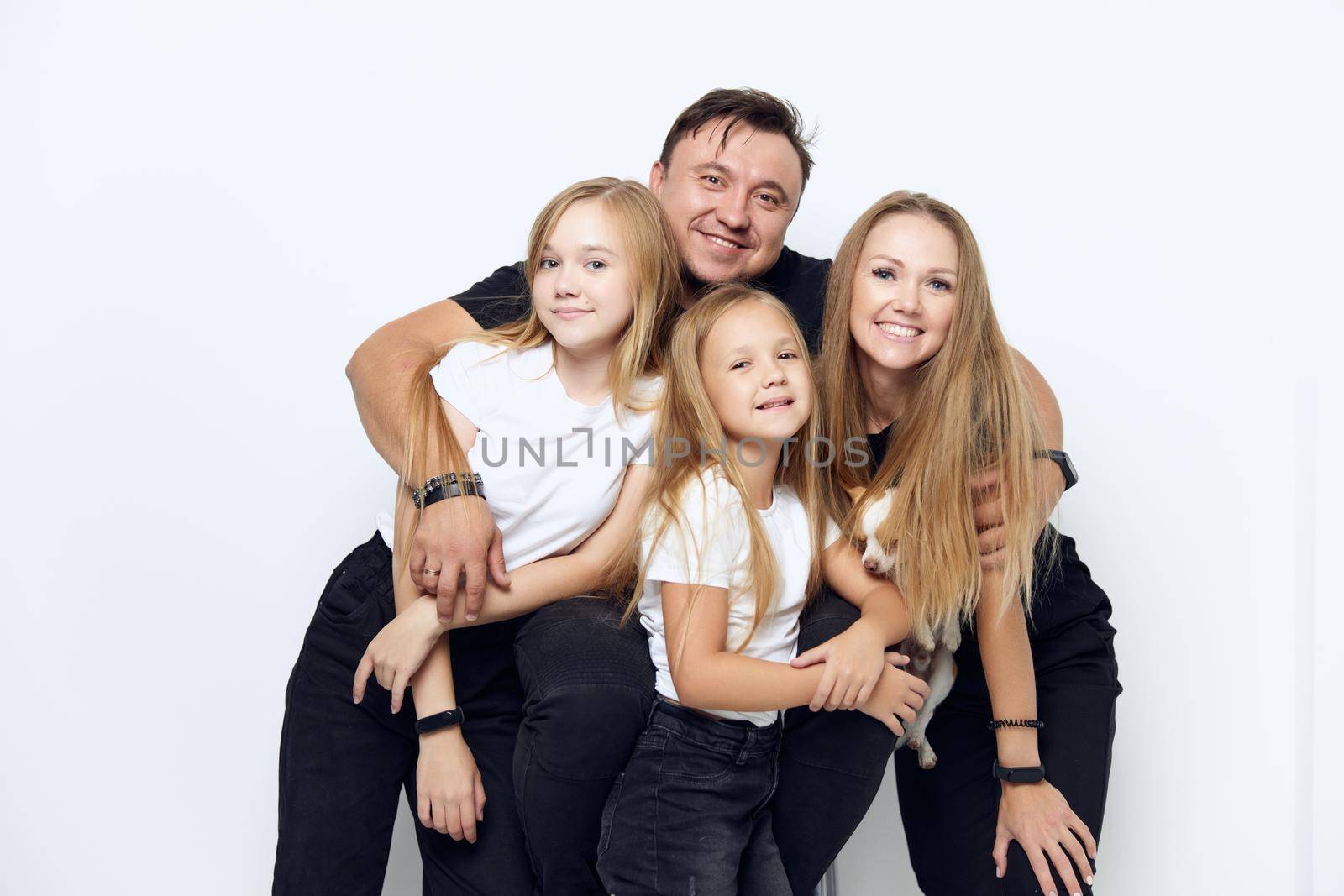 cheerful friendly family hug studio isolated background. High quality photo