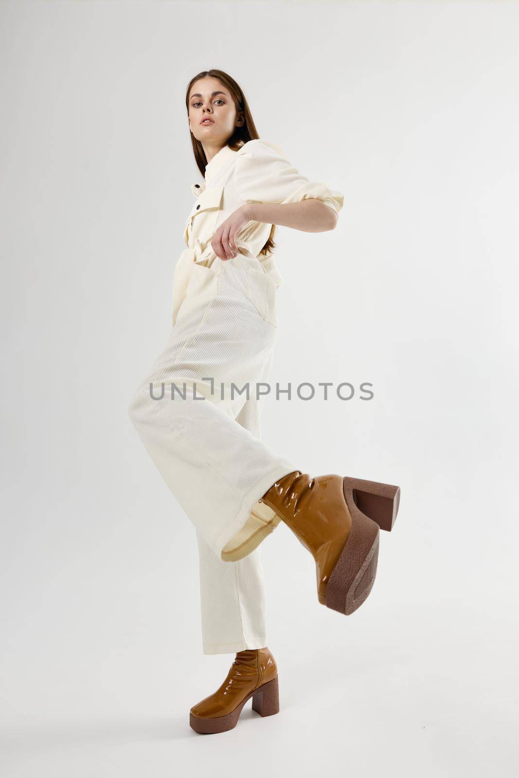 pretty woman in white suit brown shoes bottom view. High quality photo