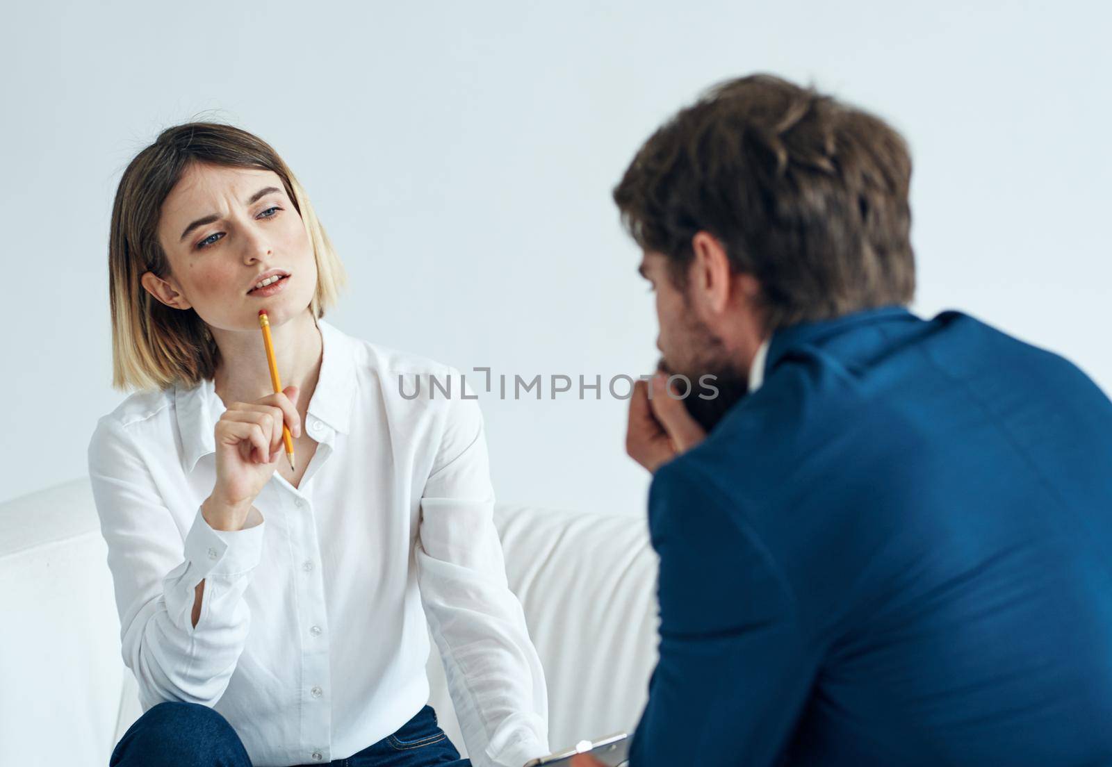 Woman on the couch and doing a man in a suit Communicating mutual understanding work. High quality photo