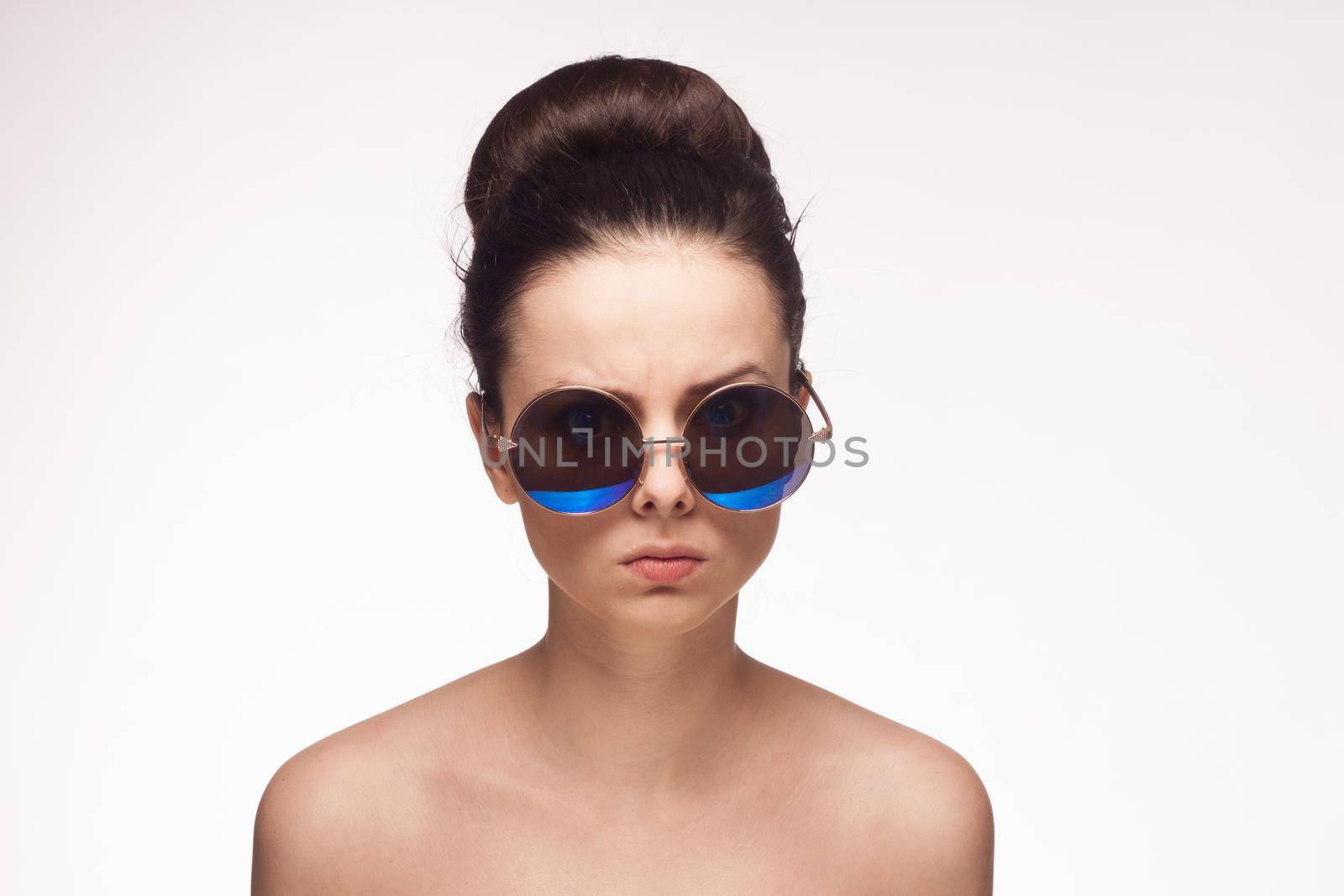 pretty woman naked shoulders sunglasses glamor light background. High quality photo