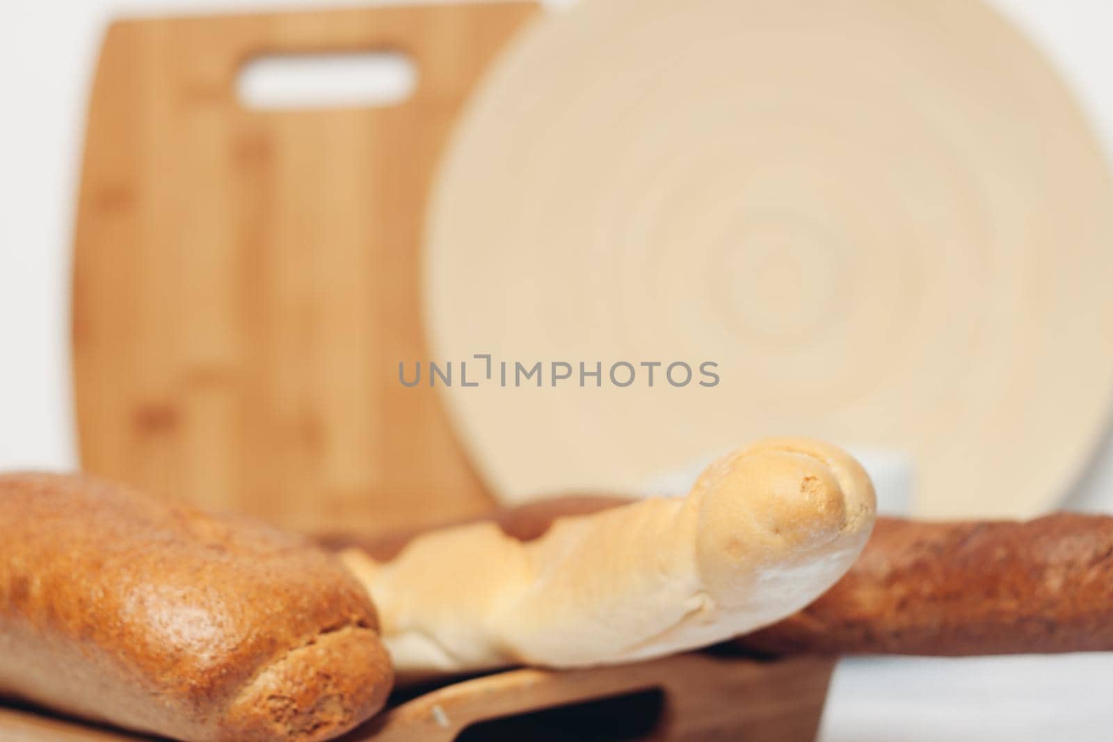 Loaf of bread cutting board spoons kitchen breakfast. High quality photo