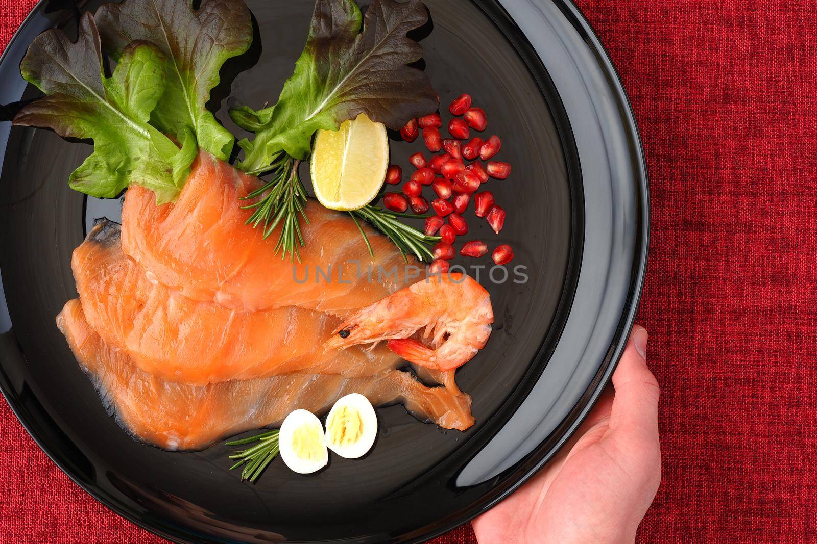 Red fish, salted salmon sliced on a beautiful black plate, fled lei. High quality photo