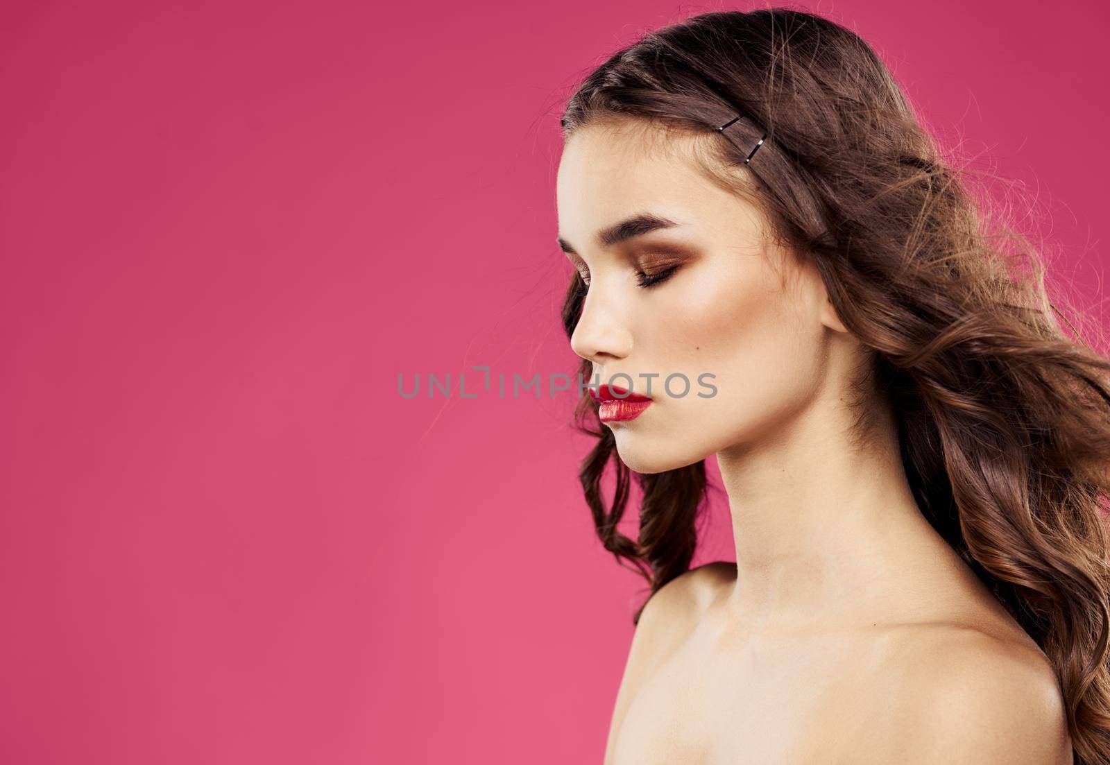 Woman on pink background with bright makeup red lips . High quality photo