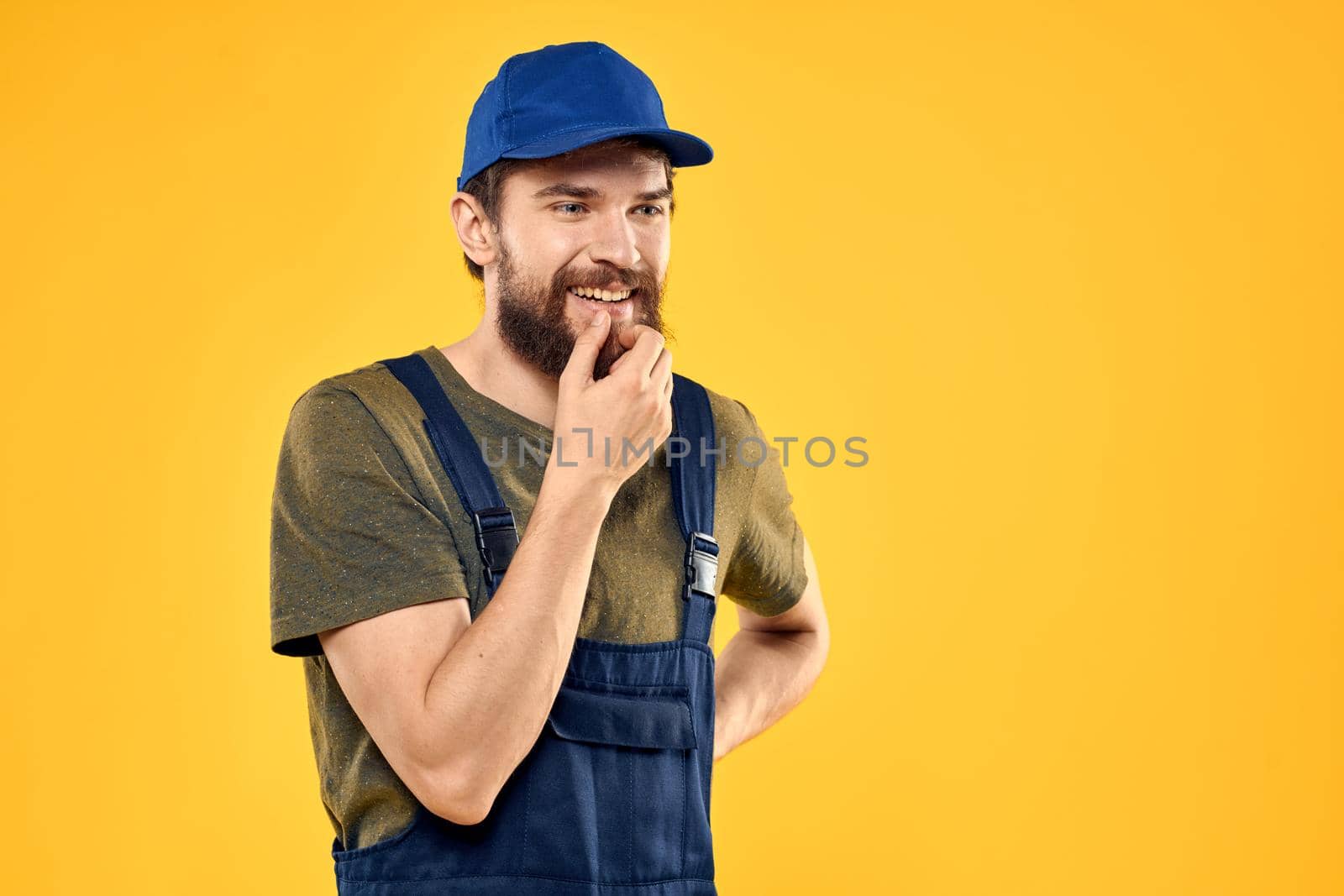 working man in uniform professional delivery service yellow background. High quality photo