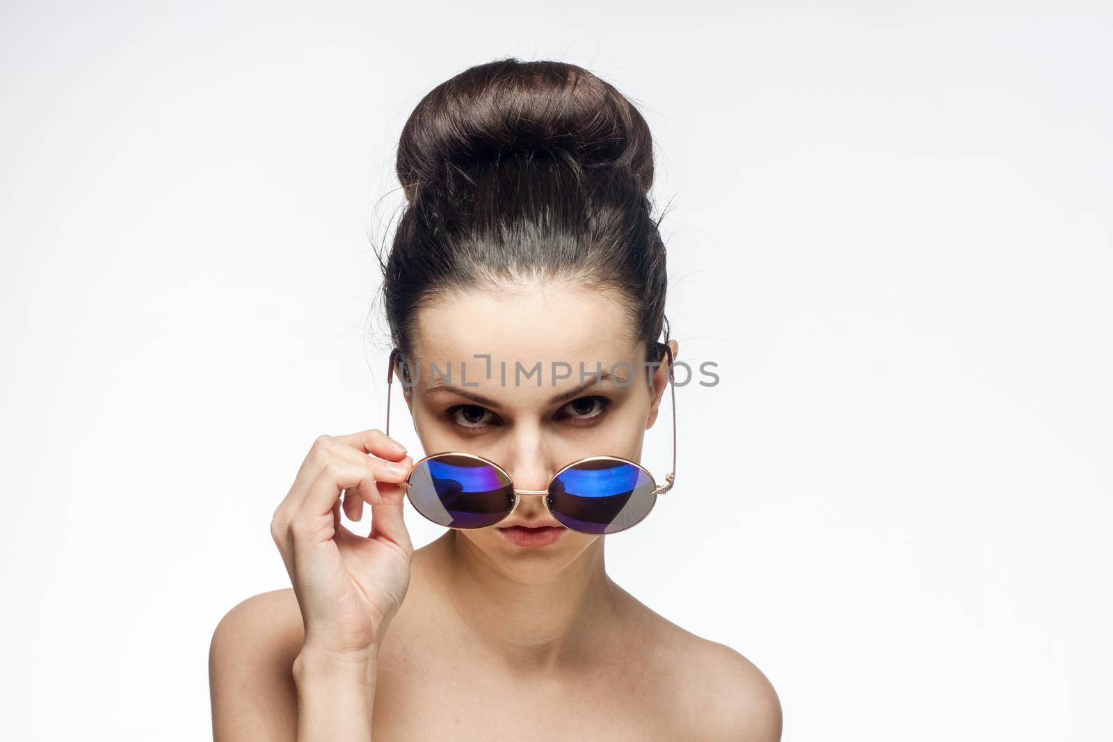 attractive woman naked shoulders sunglasses charm light background. High quality photo
