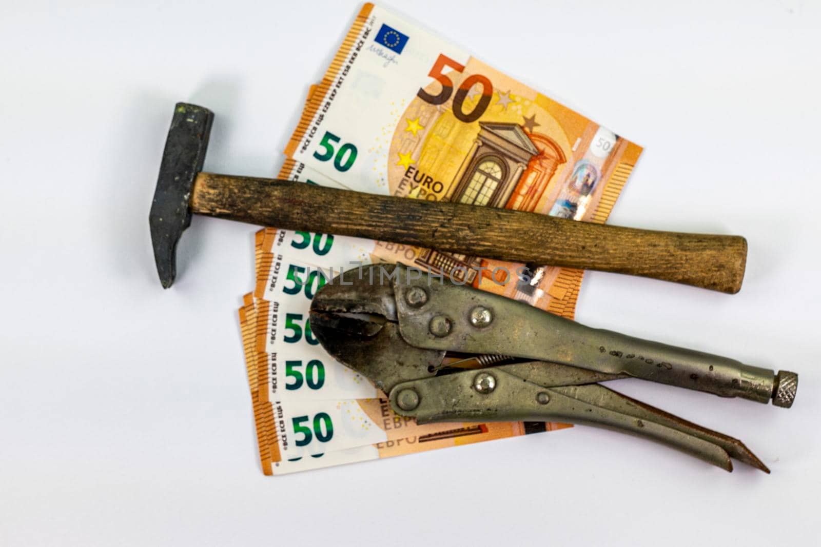 of 50 euro banknotes with work tools on a white background