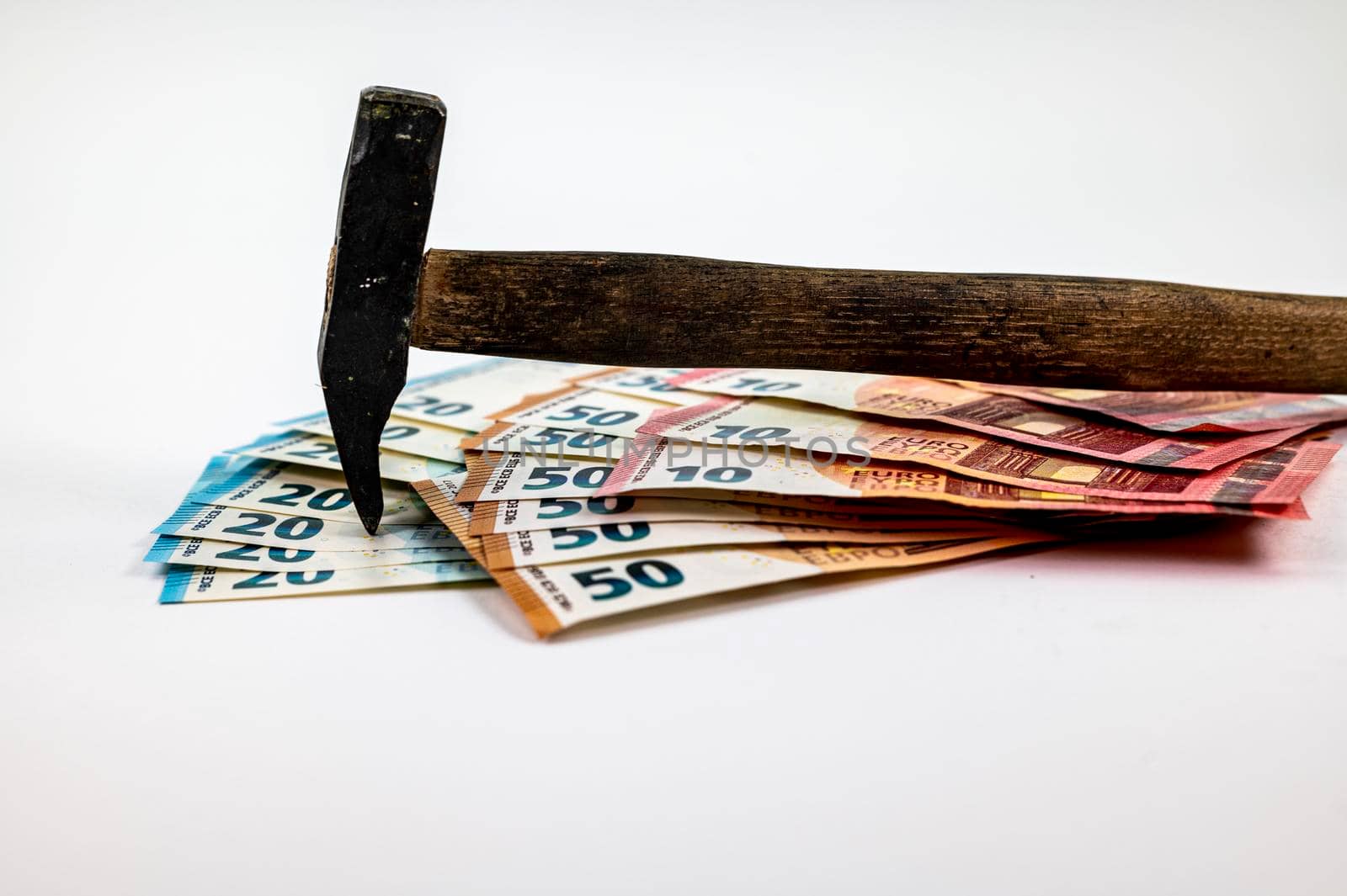 of 10 20 50 euro banknotes with work hammer on white background