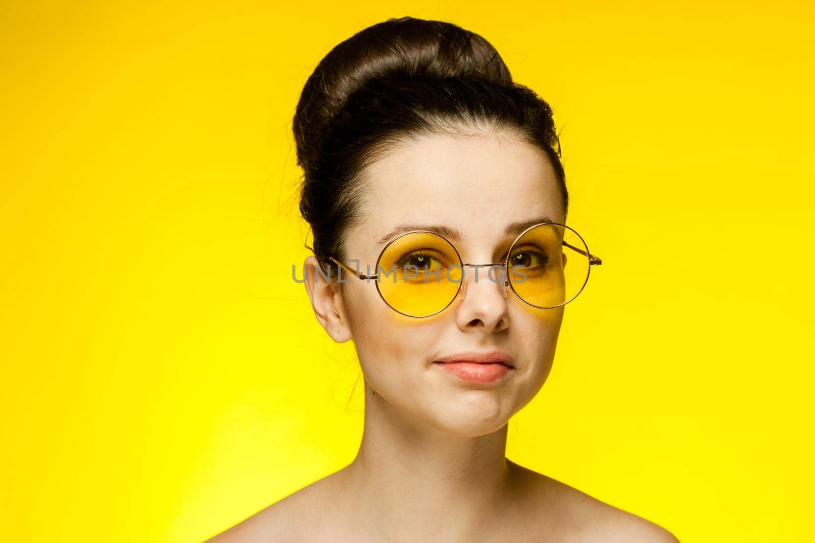 attractive woman naked shoulders yellow glasses fashion glamor. High quality photo