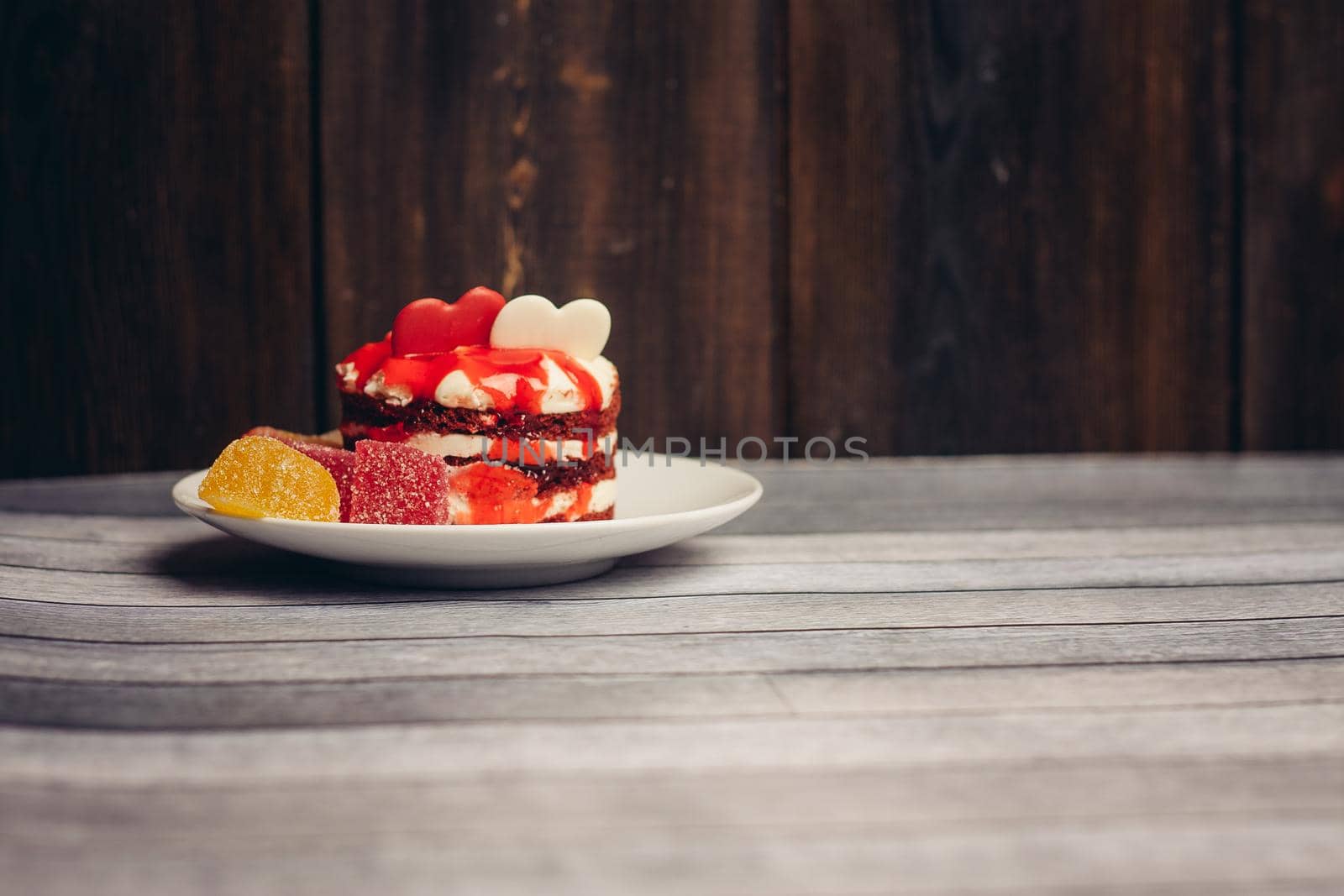 multicolored sweets marmalade snack chocolate delight wooden background. High quality photo