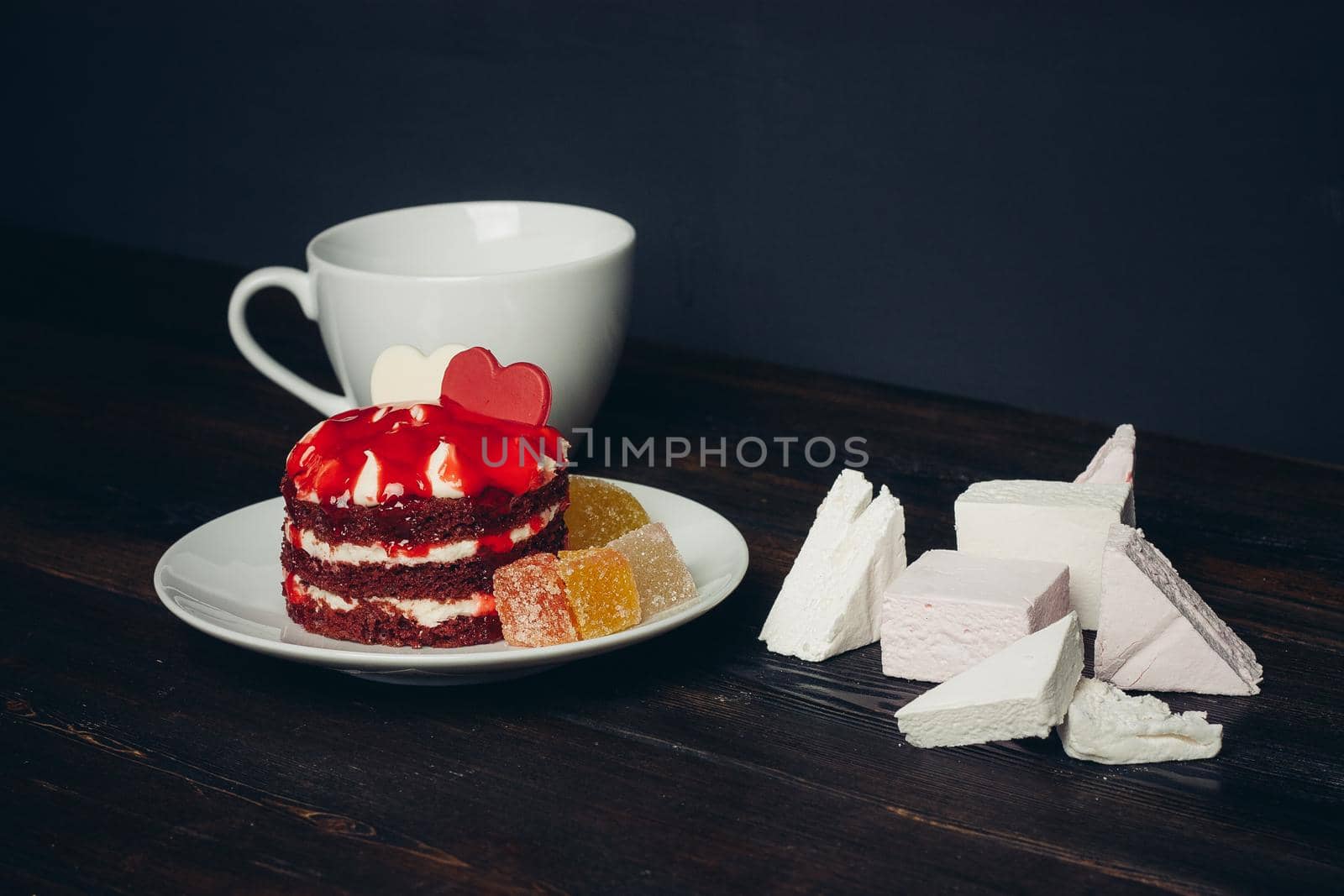Round red cake on a plate marmalade sweets dessert. High quality photo