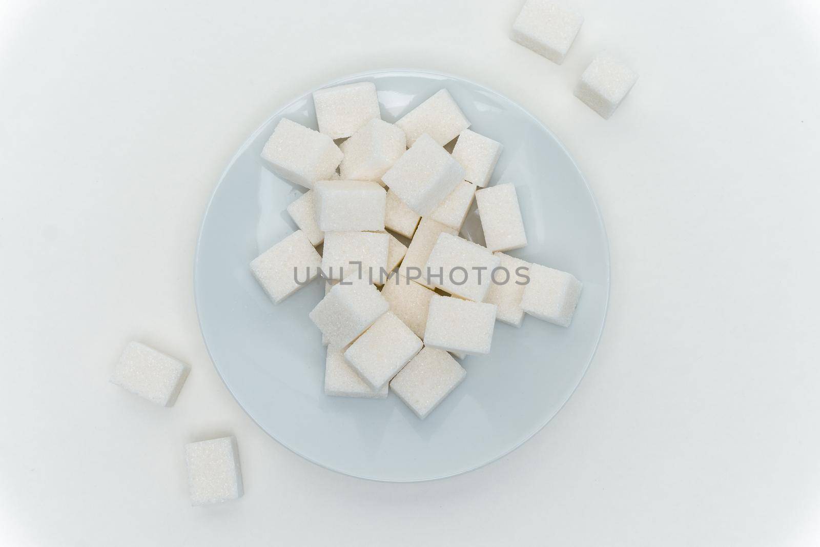 refined sugar cubes on a plate energy calories. High quality photo