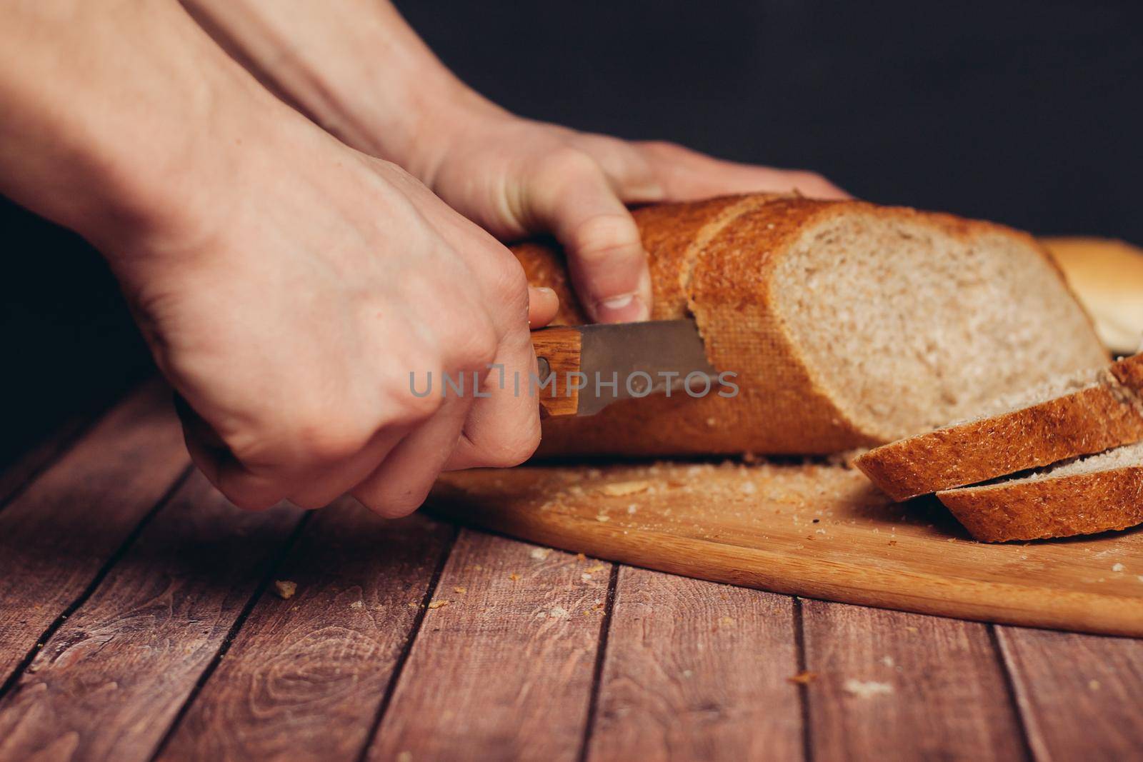 slicing loaf on a cutting board wooden table kitchen food flour product. High quality photo
