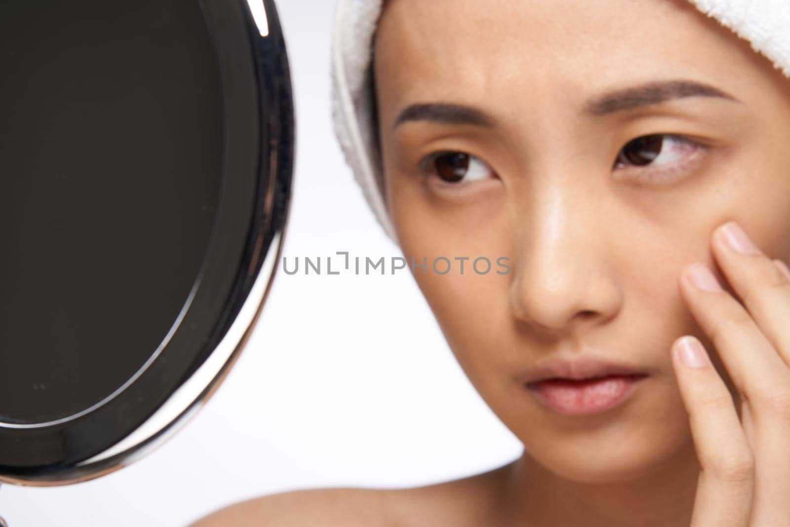 woman looking in the mirror clean skin cosmetology close-up by SHOTPRIME