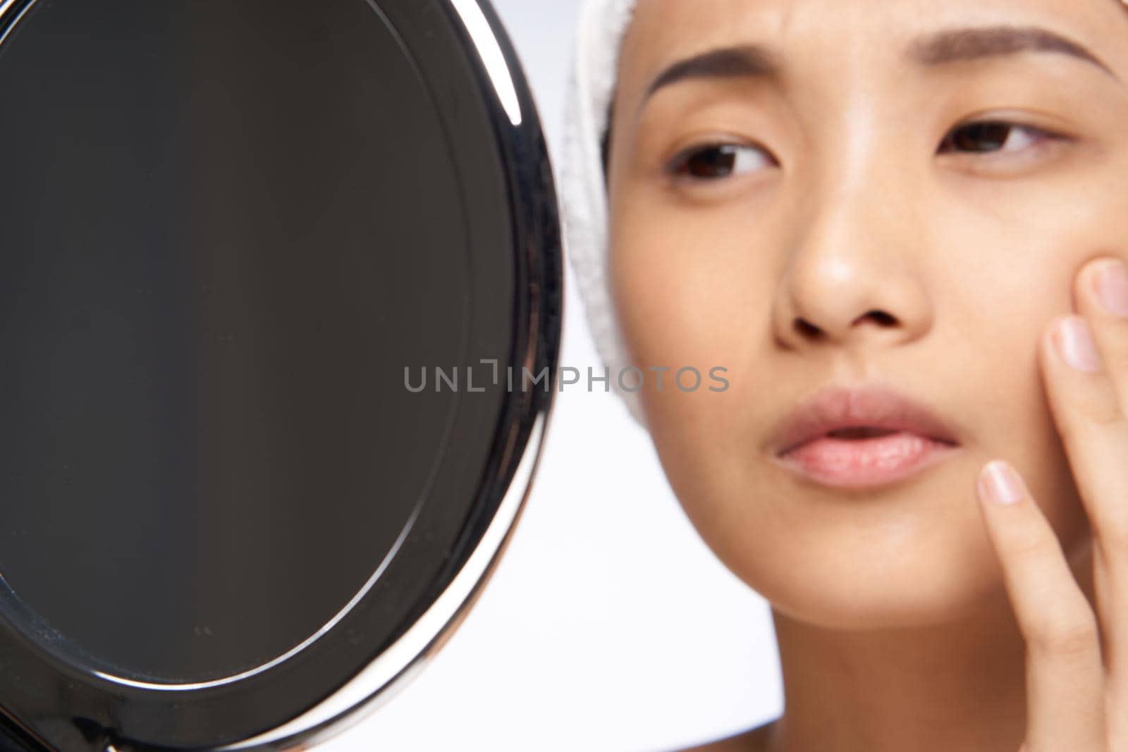 woman looking in the mirror clean skin cosmetology close-up. High quality photo