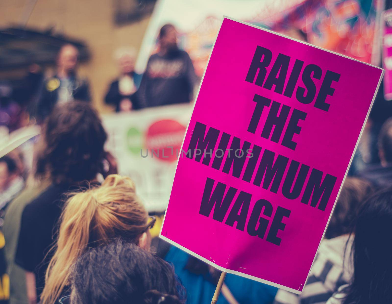 A Raise The Minimum Wage Sign At Worker's Rights Protest Or Rally