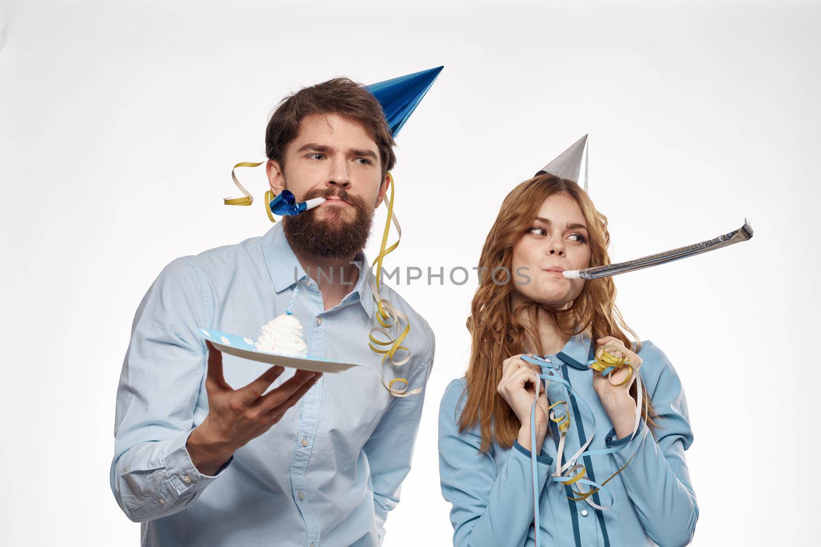 Women and men with cake holiday birthday flute fun cap corporate party. High quality photo