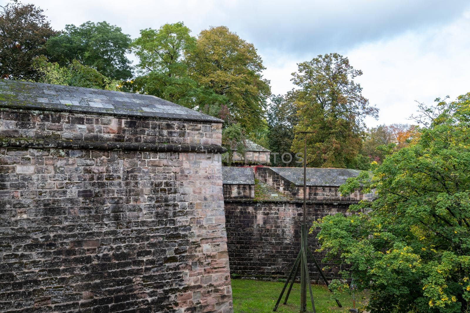 Historic wall and building of the Nuremberg castle, Bavaria, Germany  in autunm with multicolored trees