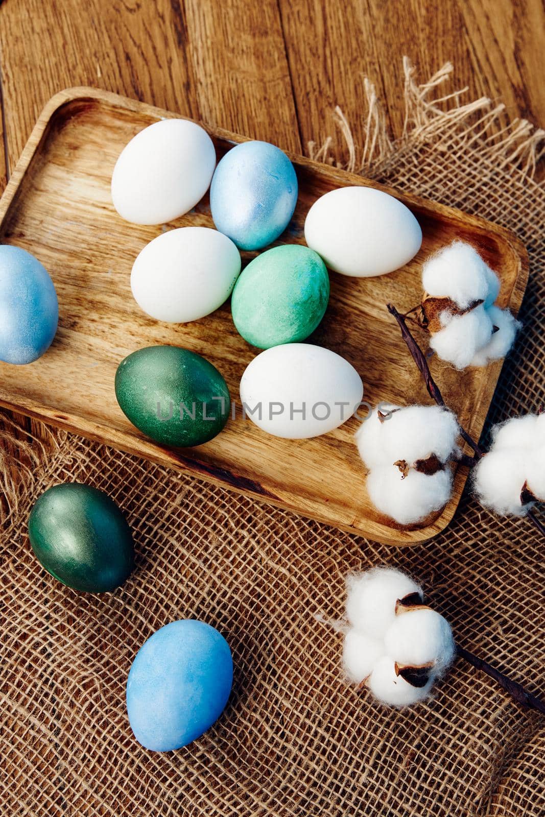 colorful easter eggs wooden background top view decoration by SHOTPRIME