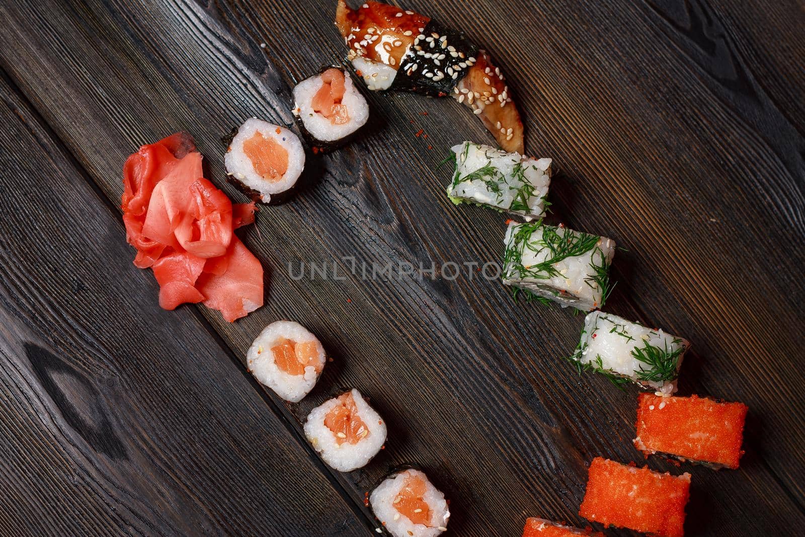 sushi rolls chopsticks japanese cuisine delivery meal wooden table. High quality photo