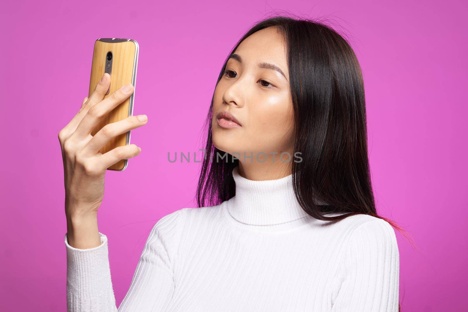 pretty woman asian appearance phone in hands communication technology cropped view by SHOTPRIME