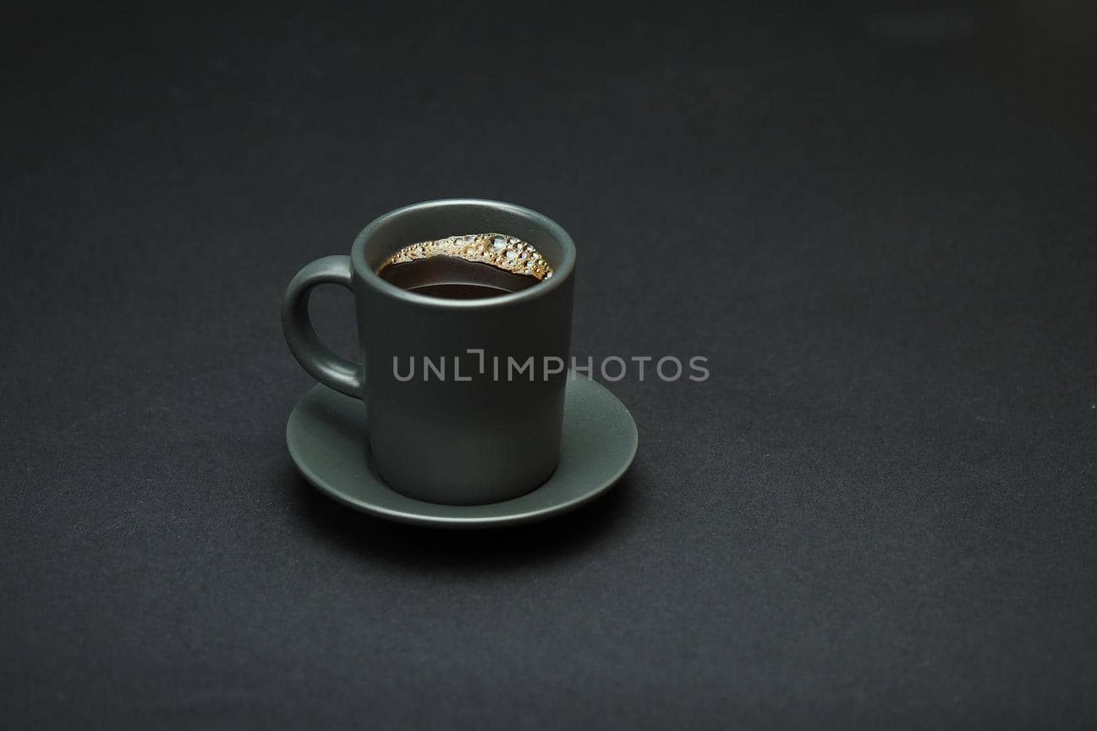 A cup of coffee on a black background. Isolated. Close-up. by Olga26