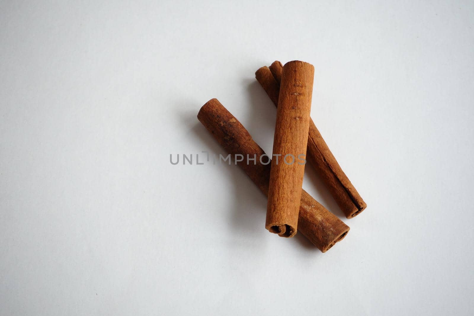 Cinnamon sticks on a white background.  by Olga26