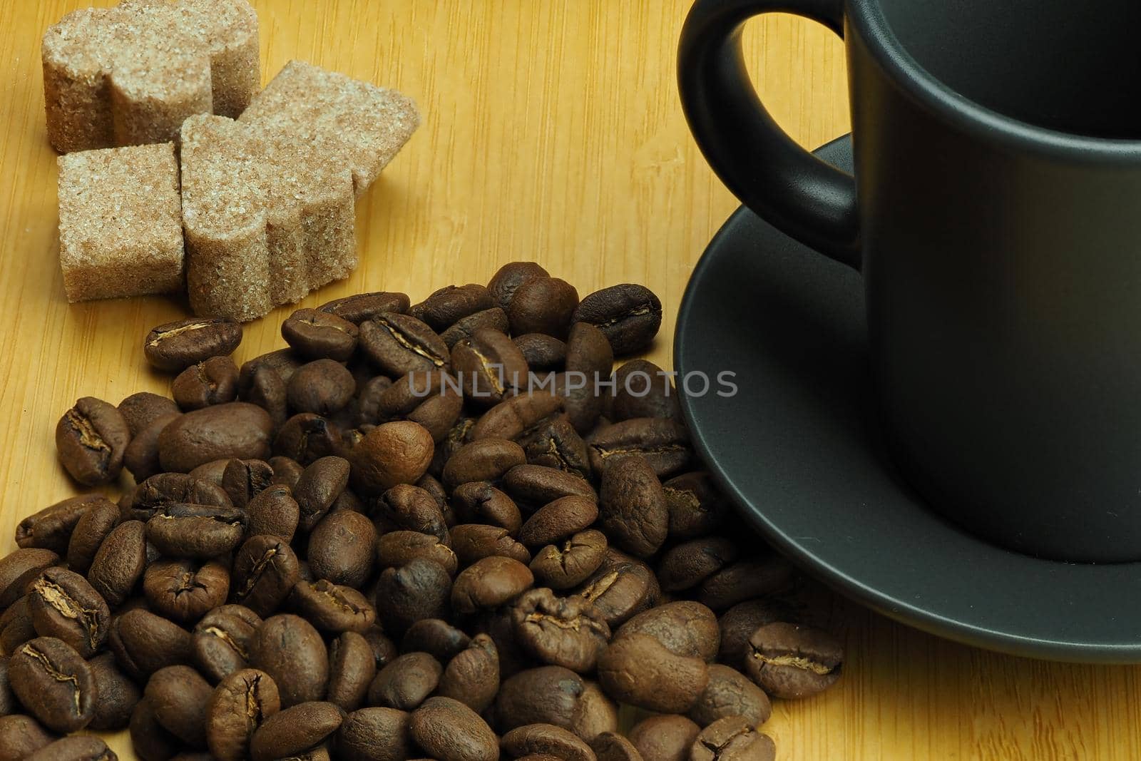 A beautiful background of natural coffee beans and a coffee cup in the background. by Olga26