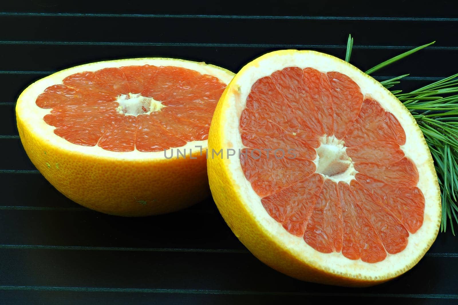 Grapefruit, cut on a black background, isolated, close-up, macro. by Olga26