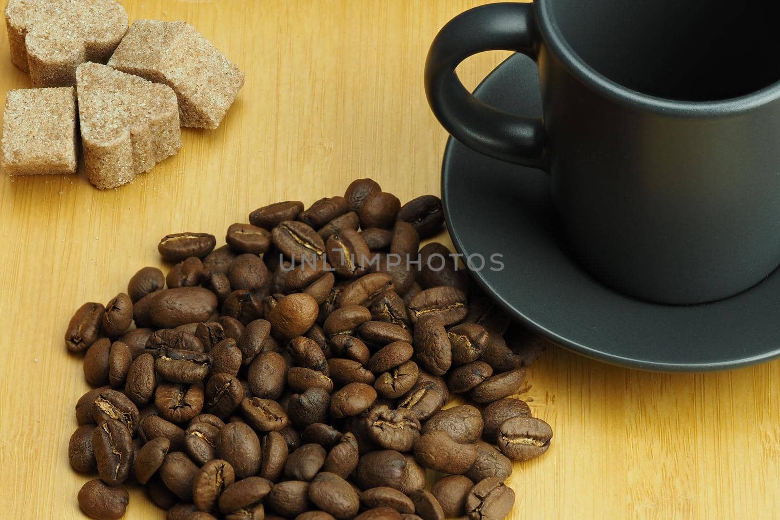 Natural coffee beans and a coffee cup in the background. High quality photo