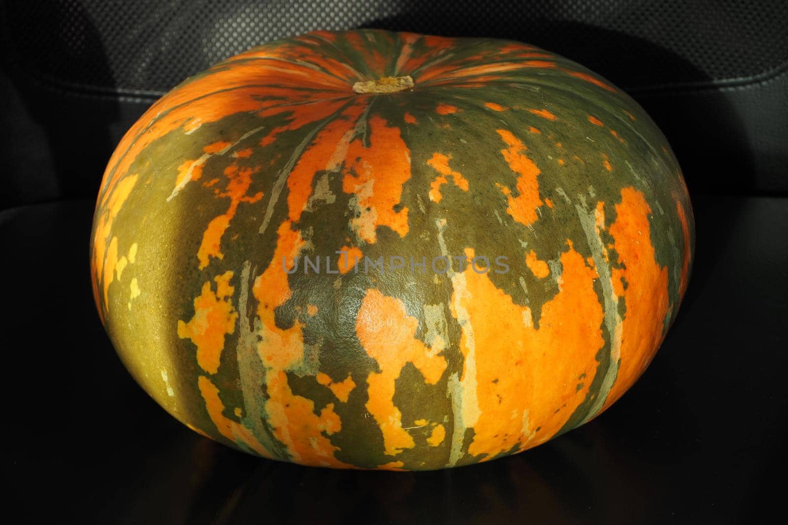 A ripe yellow pumpkin isolated on a black background. High quality photo