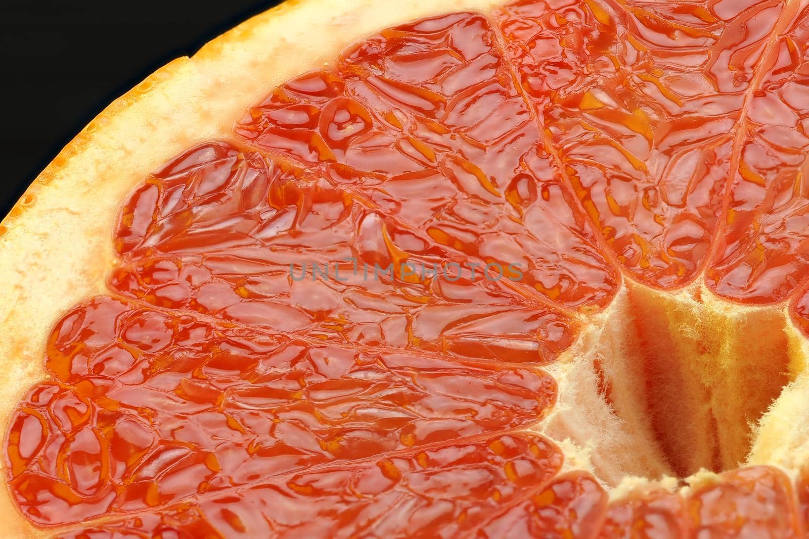 Food. A macro-beam of ripe grapefruit cut. The texture of citrus fruits. by Olga26