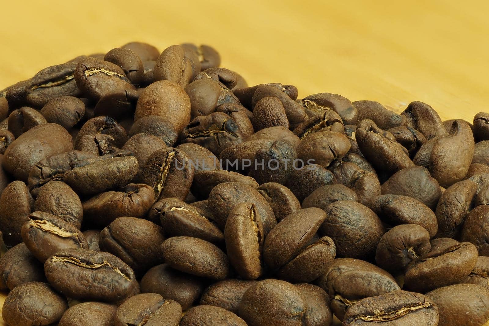 The beautiful background of their coffee is cereal. Brown background of natural coffee grains, macro-making. by Olga26